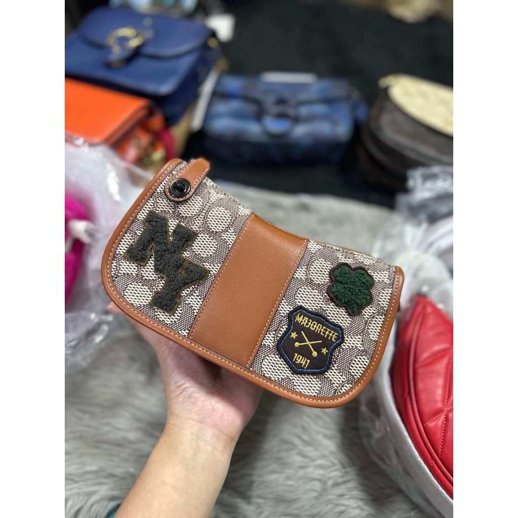 ORIG & IMPORTED CCH Retail Swinger 20 In Signature Jacquard With Varsity Patches Small Brown Bag