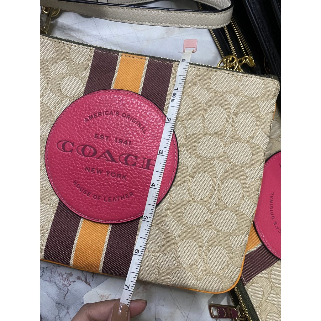 COACH pink signature buy Dempsey Wristlet