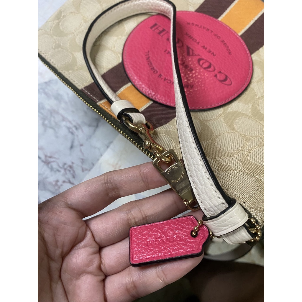 COACH pink signature buy Dempsey Wristlet